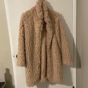 Fuzzy/Teddy Bear Coat in a very light pink color.